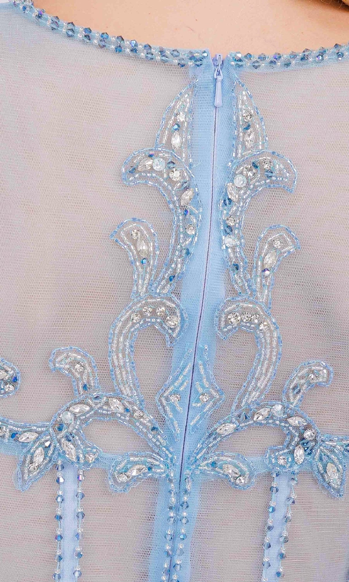 Close-up of a light blue dress with intricate beadwork